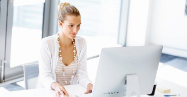 Attractive woman sitting at desk in federal office job