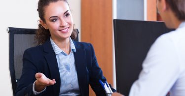 male employee having meeting with female manager in office